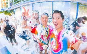 Friends enjoying the Magic Foam Experience as they are sprayed with foam.